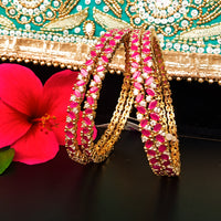 B022_S_Classy Style Gold plated Bangles studded with American Diamond stones .