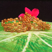 B036_Classy Gold plated bangles with flowery pattern embellished with pink and green ruby stones.