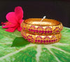 B034_Gorgeous Gold plated bangles matte finish studded with pink ruby stones.