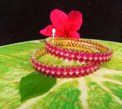 B0124_Gorgeous Gold plated bangles studded with pink ruby stones and American Diamond stones.