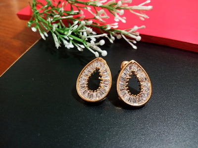 E0807_Lovely tear drop shaped gold color american diamond stone studded studs.