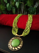 N0242_ Classic Off beat necklace with over sized circular pendant with a olive green color stone with beautiful craft work followed by layered bead chains.