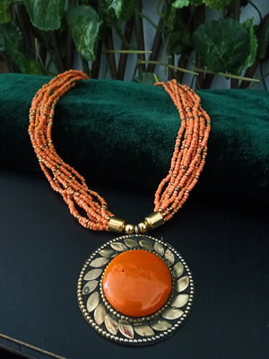 N0245_ Classic Off beat necklace with over sized circular pendant with a brown color stone with beautiful craft work followed by layered bead chains.