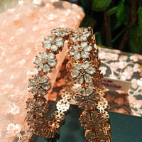 B0155_S_Elegant Rose gold bangle with flower design studded with American Diamond stones.
