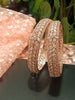 B0152_S_ Exquisite Rose Gold plated bangles with delicate art work studded with  American Diamond stones.