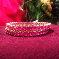 B0163_Elegant Golden crafted bangles studded with pink ruby stones with a touch of American Diamond stones.