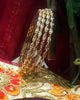 B0164_Elegant Golden sleek bangles studded with a touch of American Diamond stones.