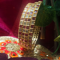 B0165_Elegant Golden bangles studded with a touch of pink ruby stones and American Diamond stones.