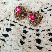 E0603_Classy circular shaped studs with a touch of pink and black stones.