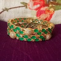 B0176_Gorgeous golden bangles embellished with American Diamond stones with a touch of green stones.