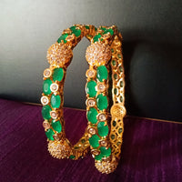 B0176_Gorgeous golden bangles embellished with American Diamond stones with a touch of green stones.