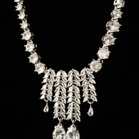 N0257_Beguiling crafted necklace set embellished with American Diamond stones with delicate stone work along with Chain drop pattern of stones.