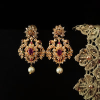 E0642_Gorgeous crafted earrings with delicate work of peacock design studded with american diamond stones with a touch of pink stones.