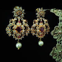 E0642_Gorgeous crafted earrings with delicate work of peacock design studded with american diamond stones with a touch of pink stones.