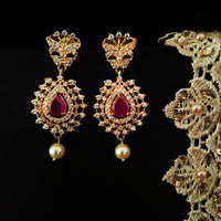 E0647_Gorgeous crafted design danglers studded with american diamond stones with a touch of pink ruby stones with a pearl drop.