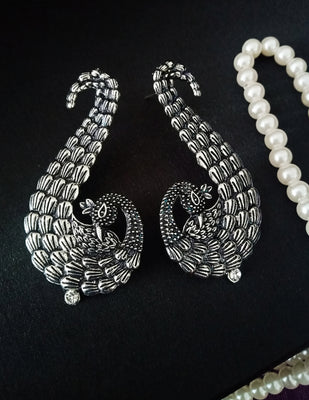 E0652_Classic german silver oxidized crafted peacock design danglers with delicate craft work studded with a touch of stones.