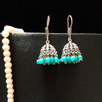 E0697_Classy german silver oxidized jumkas with delicate craft work with a touch of blue bead drops.