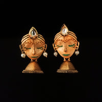 E0714_Classy crafted women face embossed earrings with a touch of pearls and stones along with a jumka drop.