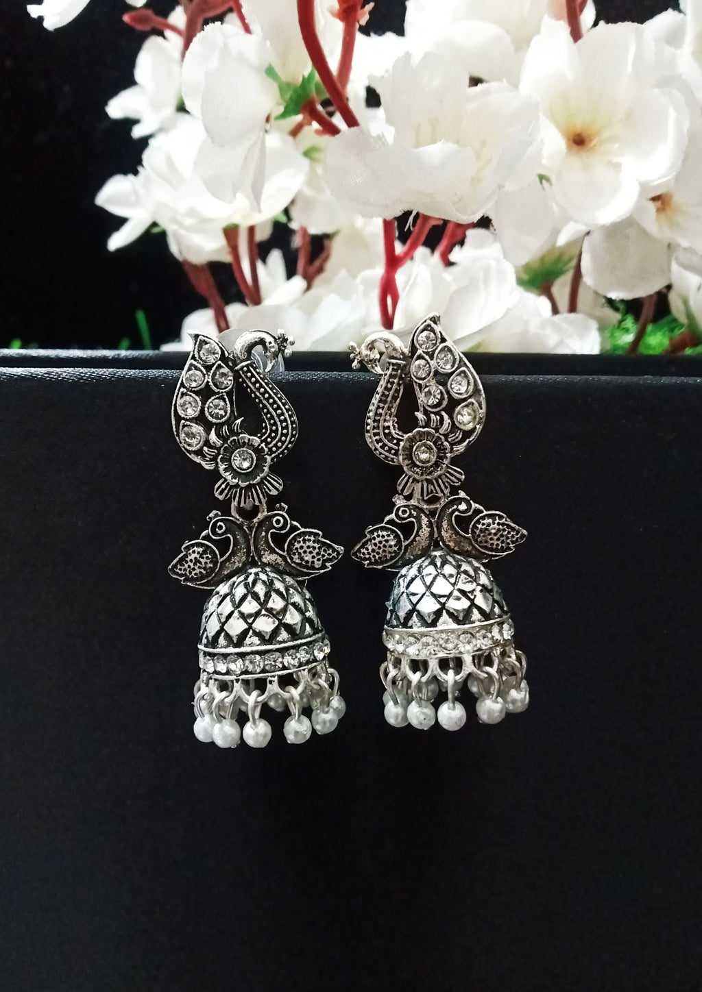 E0751_Lovely german silver oxidized peacock design jumkas with a touch of dazzling stones with a touch of pearls.