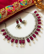 N0287_Classic crafted German Silver Oxidized magenta color choker necklace set with delicate work studded with semi precious stones with a touch of pearl drops.