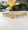 B0192_Elegant golden color bangle style bracelet studded with dazzling american diamond stones with delicate craft work.