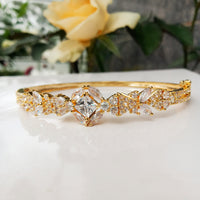 B0192_Elegant golden color bangle style bracelet studded with dazzling american diamond stones with delicate craft work.