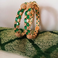 B0176_Gorgeous golden bangles embellished with American Diamond stones with a touch of green stones.