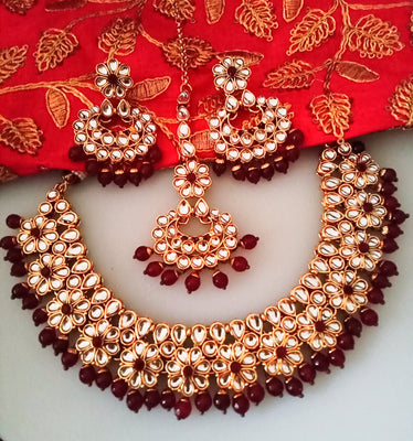 N0219_Classic Elaborated choker necklace set studded with white and maroon Kundan stones with a touch of glossy maroon beads.