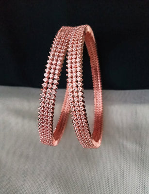 B0197_S_Elegant sleek rose gold bangles engraved with American Diamond stones with delicate stone work.