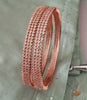 B0197_S_Elegant sleek rose gold bangles engraved with American Diamond stones with delicate stone work.