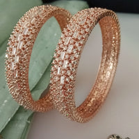 B0200_Grand broad design rose gold bangles studded with American Diamond stones with delicate stone work.