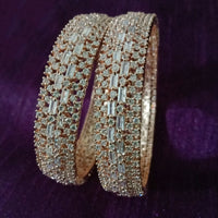B0200_Grand broad design rose gold bangles studded with American Diamond stones with delicate stone work.