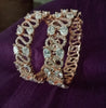 B0196_S_Beguiling broad rose gold designer bangles engraved with American Diamond stones.