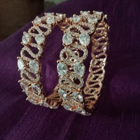 B0196_S_Beguiling broad rose gold designer bangles engraved with American Diamond stones.