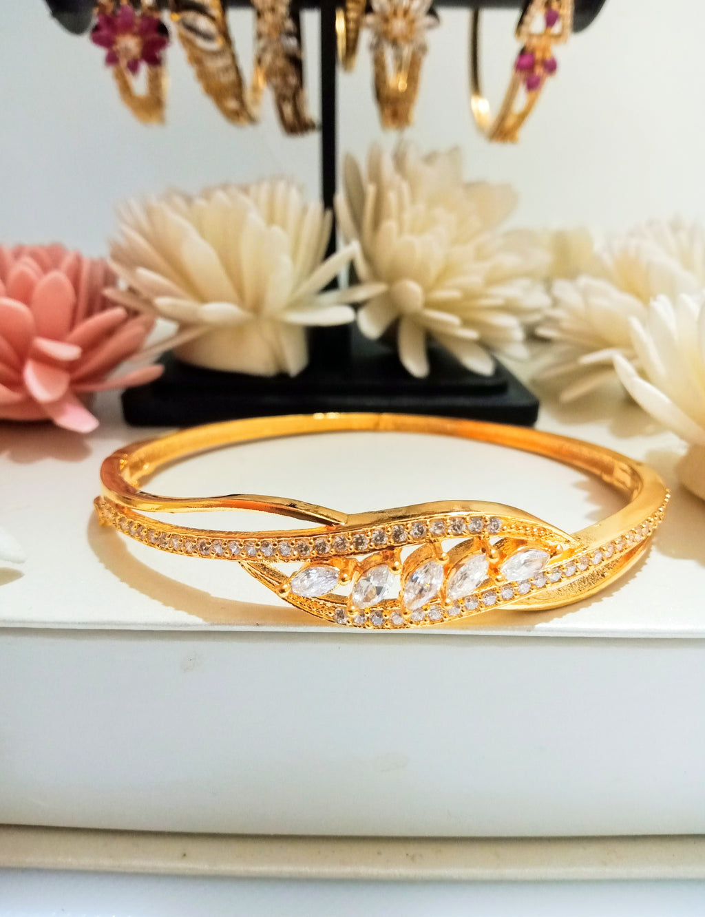 B0203_Elegant design golden color bangle style bracelet studded with dazzling american diamond stones with delicate design.