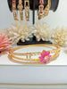 B0195_Lovely golden color bangle style flower design bracelet studded with dazzling american diamond stones with a touch of pink stones.