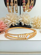 B0193_Elegant sleek design golden color bangle style bracelet studded with dazzling american diamond stones.