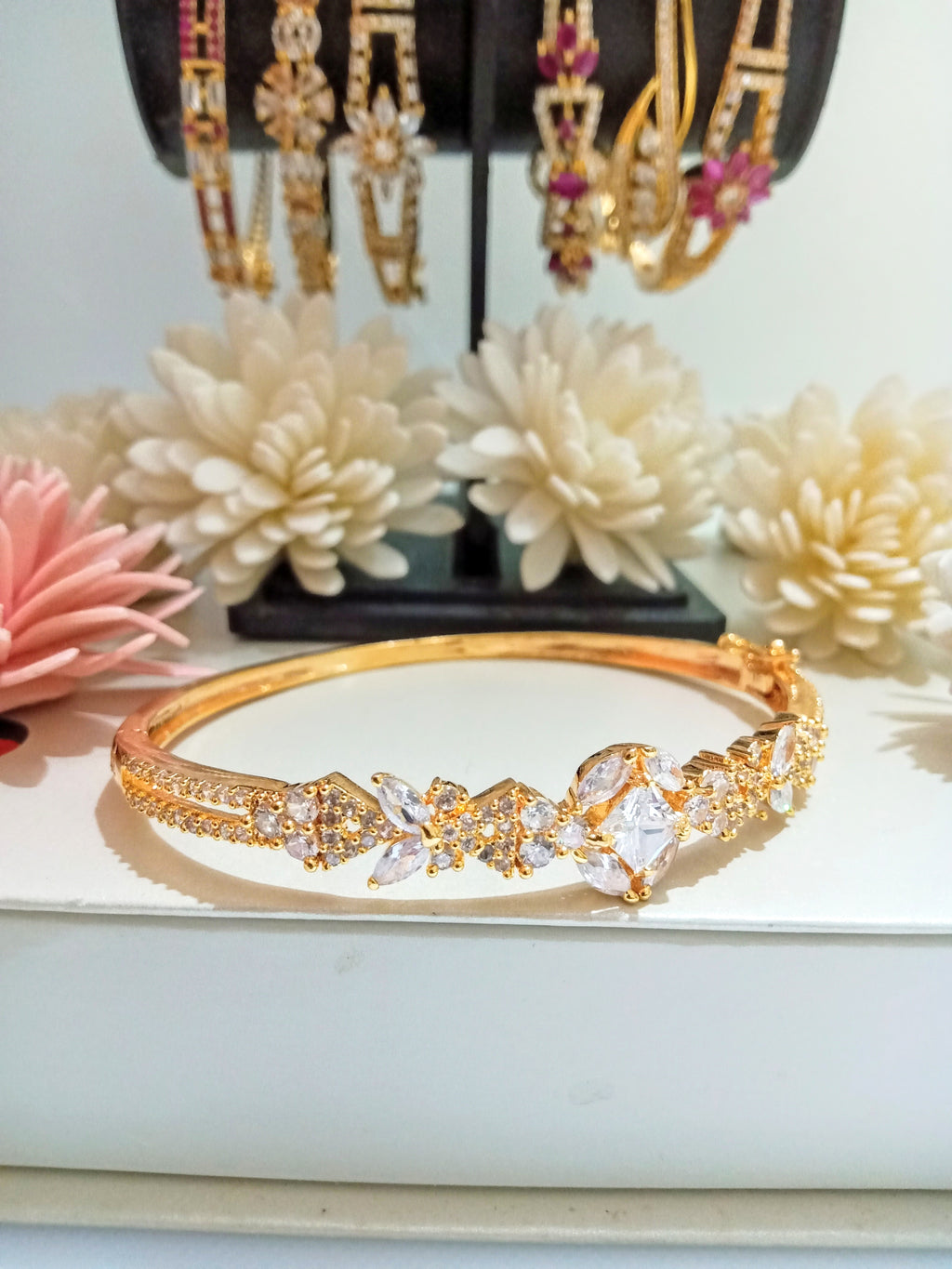 B0192_Elegant golden color bangle style bracelet studded with dazzling american diamond stones with delicate craft work.