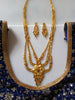 N0176_Ravishing traditional style Gold plated long layered grand necklace set with fine artwork of floral designs studded with pink and green ruby stones with a touch of broad chain drop pendant.