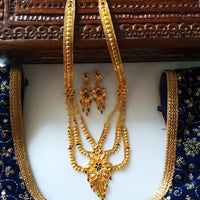 N0176_Ravishing traditional style Gold plated long layered grand necklace set with fine artwork of floral designs studded with pink and green ruby stones with a touch of broad chain drop pendant.