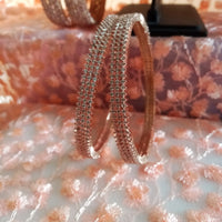 B0197_S_Elegant sleek rose gold bangles engraved with American Diamond stones with delicate stone work.