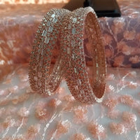 B0200_Grand broad design rose gold bangles studded with American Diamond stones with delicate stone work.