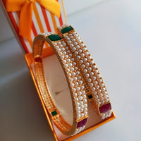 B0211_Classic pearl studded bangles with delicate craft work with a touch of pink & green ruby stones.