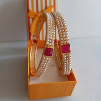 B0211_Classic pearl studded bangles with delicate craft work with a touch of pink & green ruby stones.