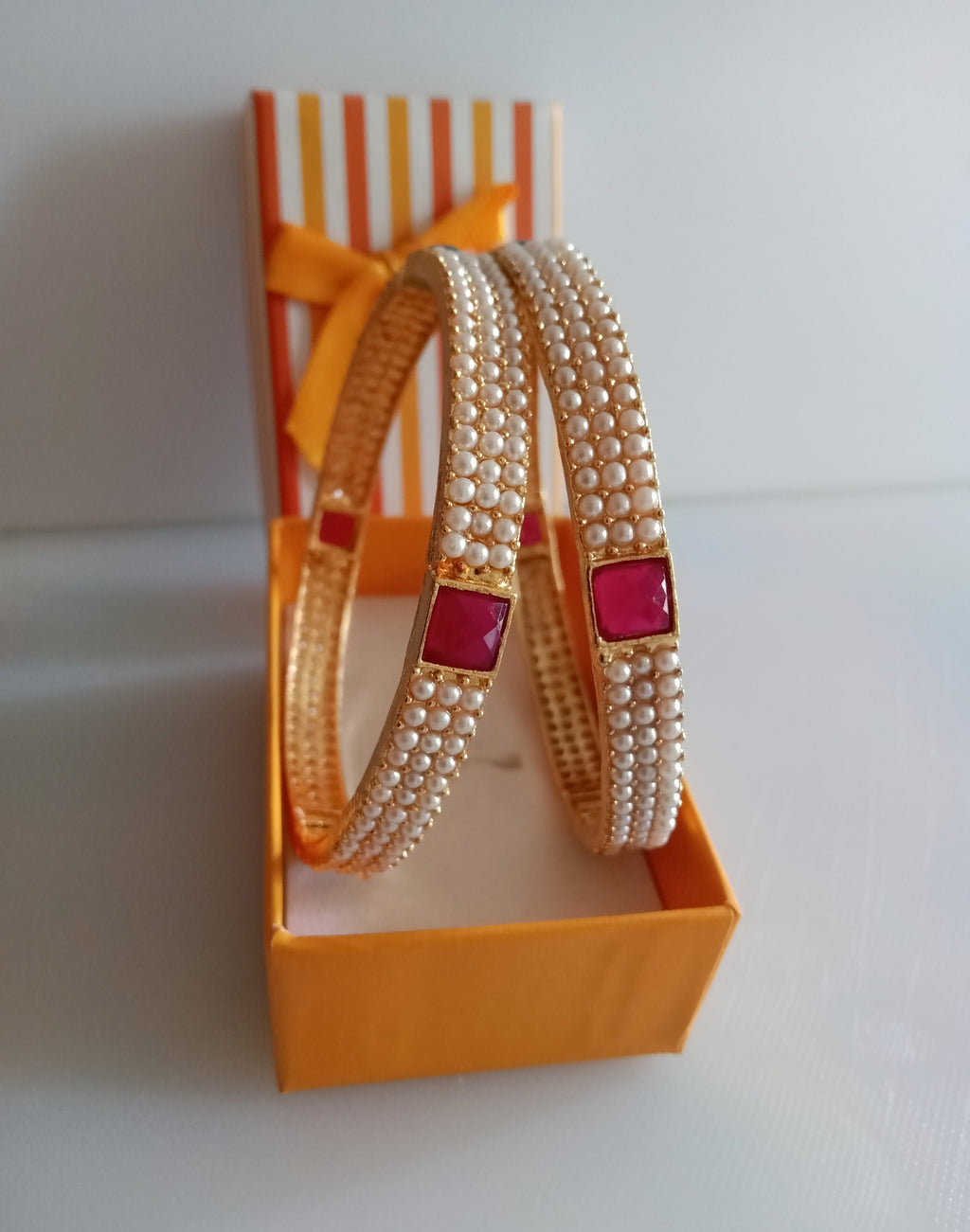 B0211_Classic pearl studded bangles with delicate craft work with a touch of pink & green ruby stones.