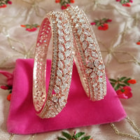 B0152_S_ Exquisite Rose Gold plated bangles with delicate art work studded with  American Diamond stones.