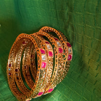 B0221_Beautiful golden bangles with delicate craftwork with a touch of stones.
