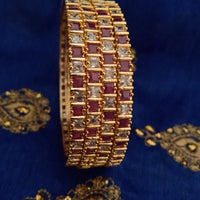 B0165_Elegant Golden bangles studded with a touch of pink ruby stones and American Diamond stones.