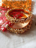 B0222_Lovely golden pearl bangles with delicate craftwork embellished with a bunch of pearls.