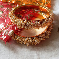 B0222_Lovely golden pearl bangles with delicate craftwork embellished with a bunch of pearls.